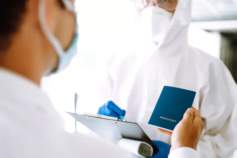 Patient holding a passport during a medical examination