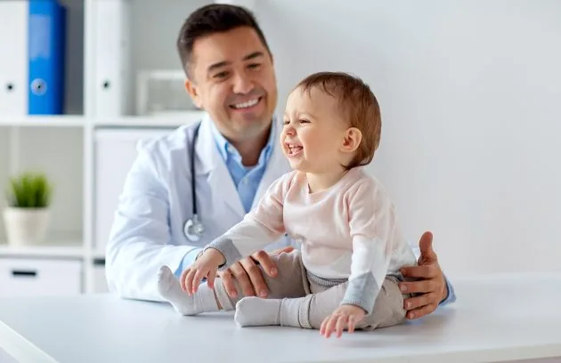 Clinician with a young child on an examination table