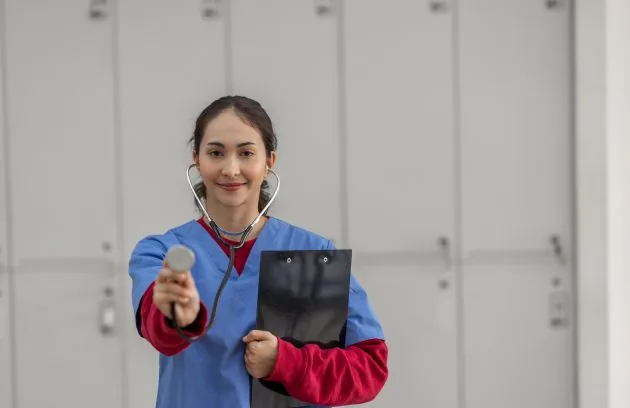 Clinician holding a stethoscope and clipboard