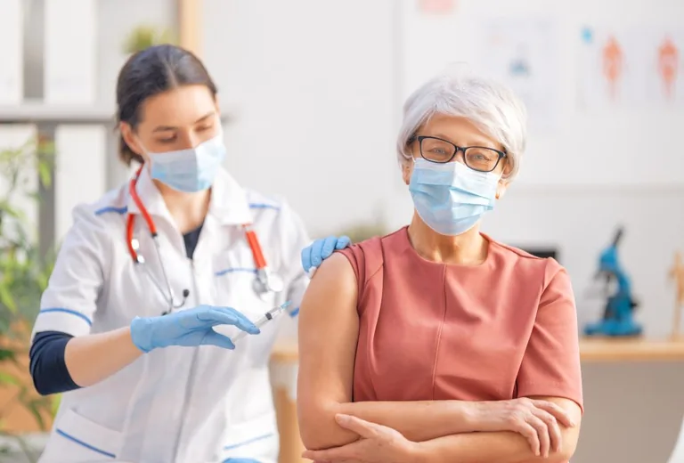 Clinician giving an adult patient a vaccination