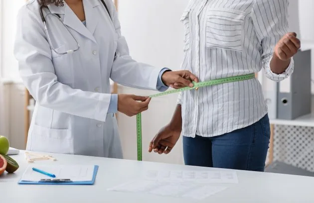 Clinician measuring a patient's waist